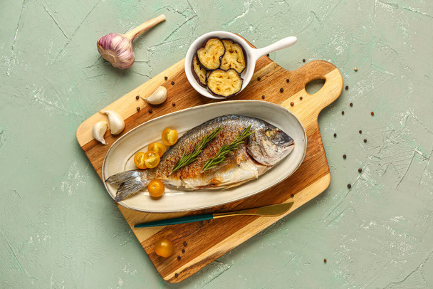 Plate with tasty grilled dorado fish on grey background - Photo, Image