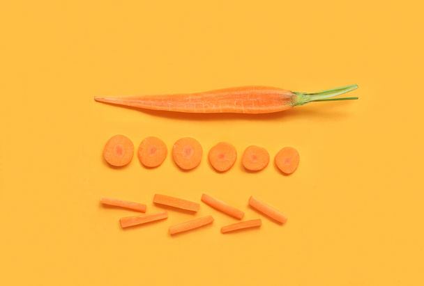 Slices of fresh carrot on orange background - Foto, imagen