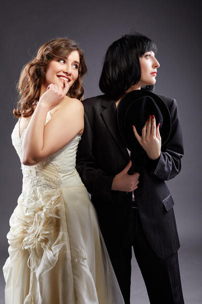 Elegant lesbian couple posing as bride and groom - Foto, afbeelding