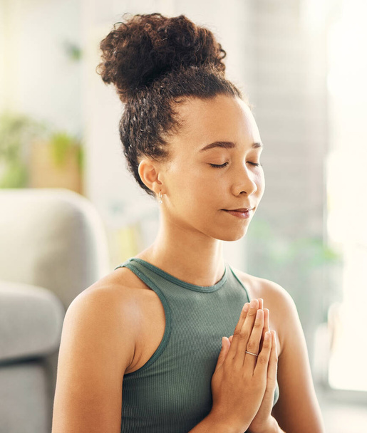 Praying hands, meditation and woman relax in living room for peace, wellness or mental health balance at home. Prayer pose, yoga and lady meditate in lounge for zen, healing or holistic exercise. - Zdjęcie, obraz
