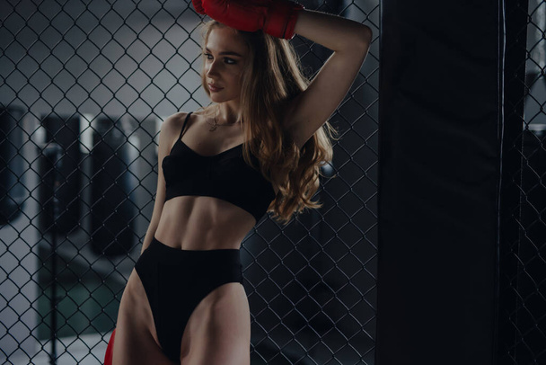 Sexy woman boxer in bra and panties posing at the box club - Foto, Imagen