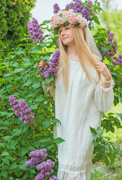 European Slavic Tradition, bride woman in white dress, flower wreath with a veil on a head. Tender girl - Φωτογραφία, εικόνα