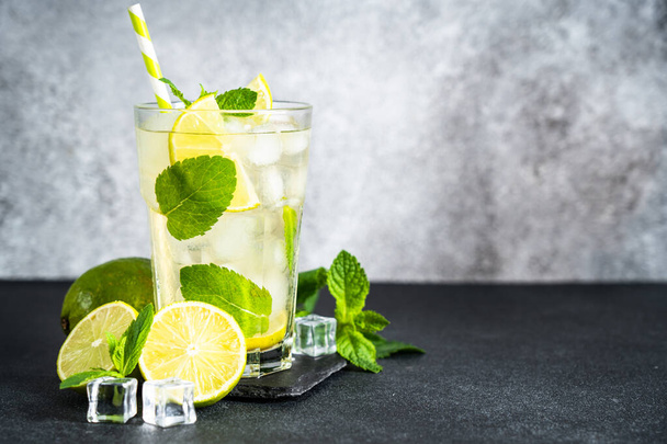 Mojito with rum and lime on black background. Tradition Summer drink with ice. - Φωτογραφία, εικόνα