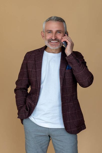 Phone call. Mature businessman talking on the phone - Photo, Image