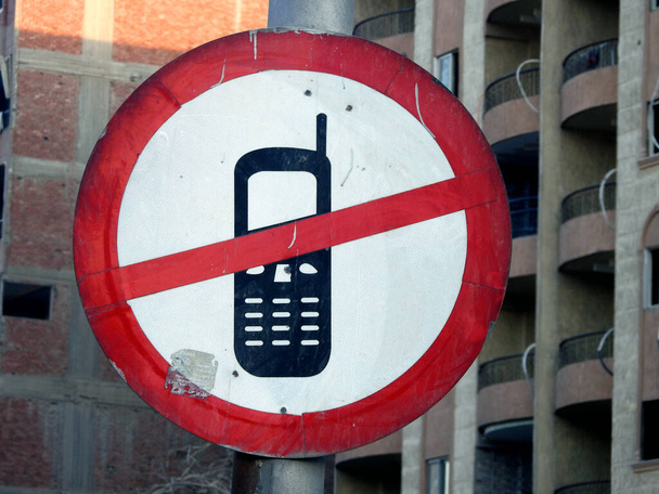 Ningún uso del teléfono celular durante el signo de conducción, un letrero de tráfico muestra que el uso de un teléfono móvil está restringido y prohibido durante la conducción, incluyendo hablar, leer y enviar mensajes de texto, enfoque selectivo - Foto, Imagen