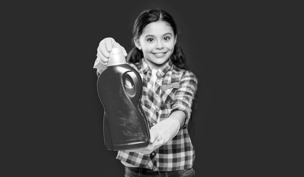 girl household with detergent on background, selective focus. photo of girl household with detergent. girl household with detergent isolated on red. girl household with detergent in studio. - Foto, Imagen