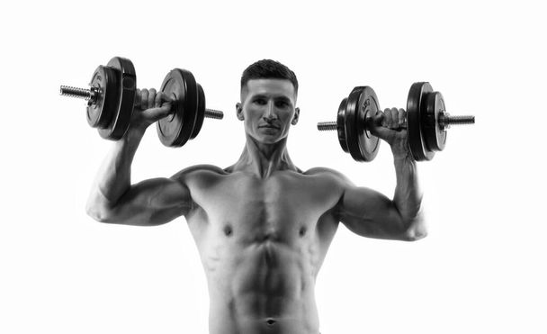 sport man with dumbbell having torso on background. photo of sport man with dumbbell. sport man with dumbbell isolated on white. sport man with dumbbell in studio. - Photo, Image