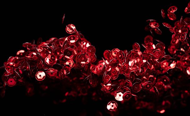 Explosion metallic red glitter sequin sparkle. Red Glitter sequin spark blink celebrate, blur foil explode in air, fly throw red particle. Black background isolated, selective focus Blur bokeh - Photo, Image