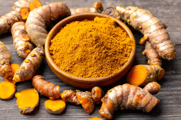 The turmeric powder is a natural herb and is an ingredient for food cooking. The colour of the turmeric powder is yellow when it dry and green when it raw. Asian curry like Indian has yellow powder. - Photo, Image