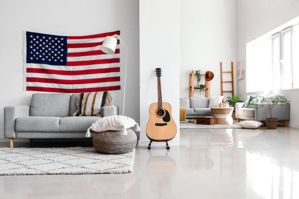 Interior of modern living room with hanging USA flag - 写真・画像