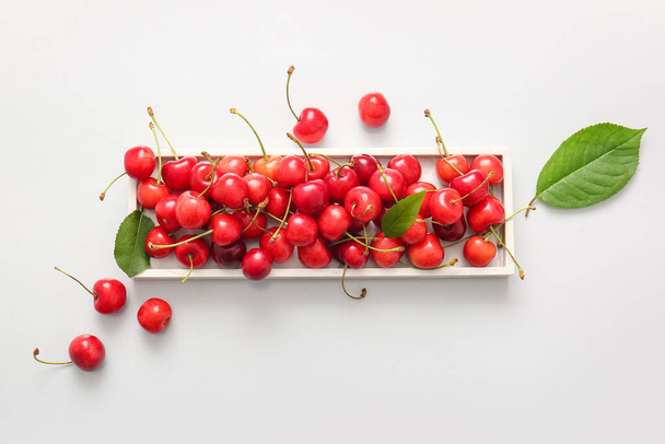 Tray with sweet cherries on white background - Photo, Image