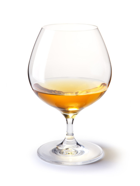 Cognac glass with gold cognac on a white with shadow - Photo, image