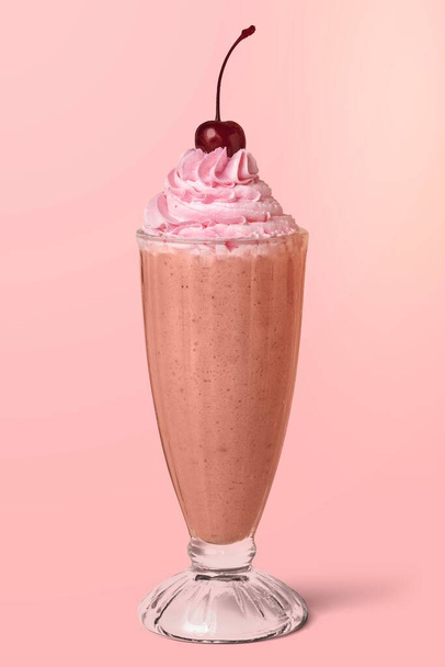 Strawberry milkshake with a maraschino cherry on background - Foto, Bild