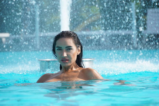 sexy girl in a transparent dress in a swimming pool   - Zdjęcie, obraz
