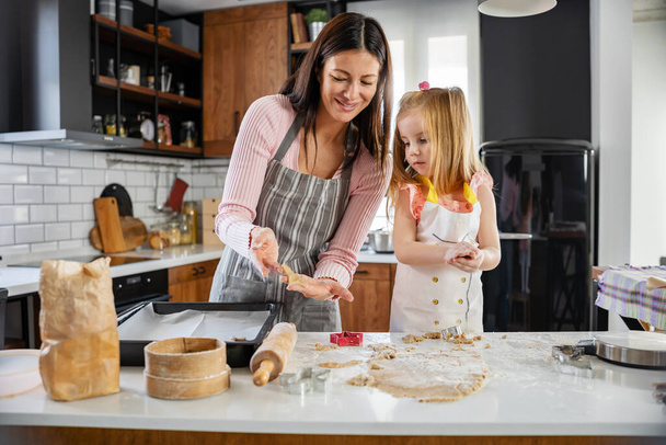 mother and daughter cooking together at home  - Photo, Image