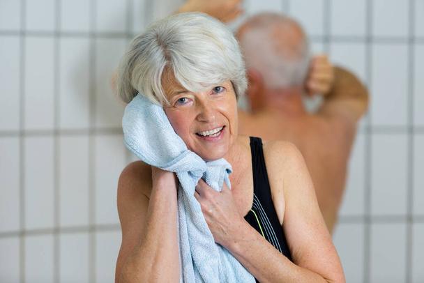 senior woman drying herself after swimming pool - Foto, Bild