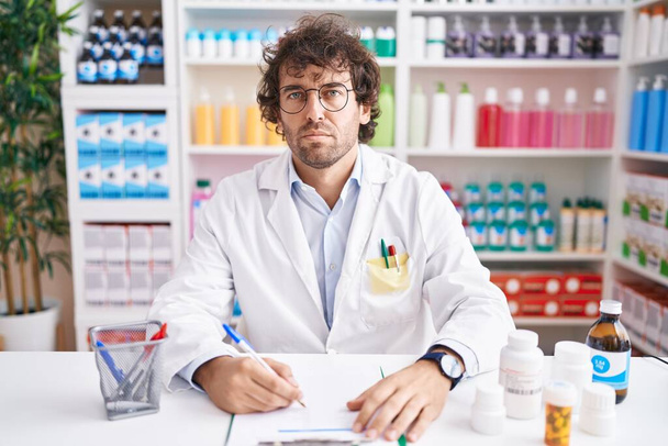 Hispanic young man working at pharmacy drugstore skeptic and nervous, frowning upset because of problem. negative person.  - Fotoğraf, Görsel
