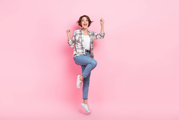 Full body photo of astonished business lady raise fists up jumping crazy celebrate black friday discounts isolated on pink color background. - Foto, immagini