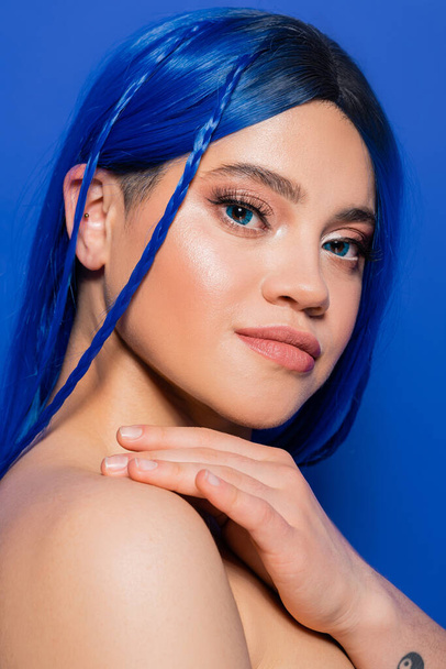 skin perfection, young woman with dyed hair posing on blue background, hair color, individualism, female model with makeup and trendy hairstyle, vibrant youth, beauty trends  - Foto, afbeelding