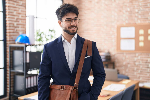 Young hispanic man business worker smiling confident standing at office - Foto, Imagen