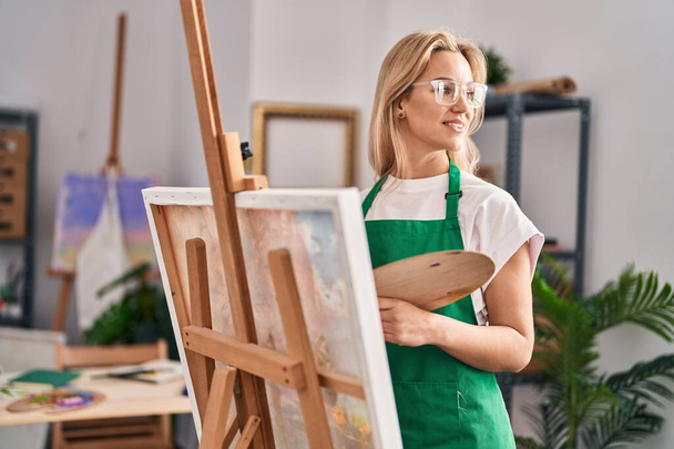 Young blonde woman artist smiling confident drawing at art studio - Photo, Image
