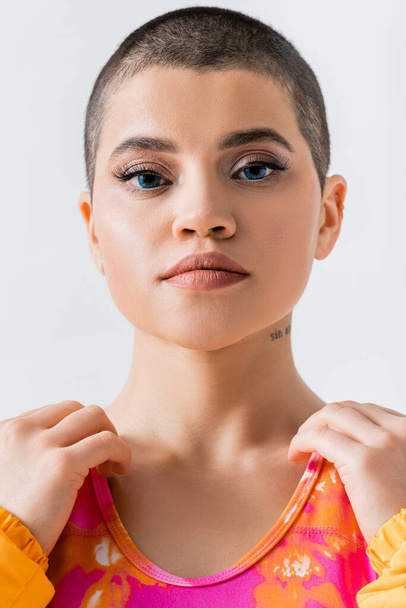 makeup and style, portrait of tattooed young woman with short hair looking at camera on grey background, generation z, fashion forward, female model, self expression  - Photo, Image