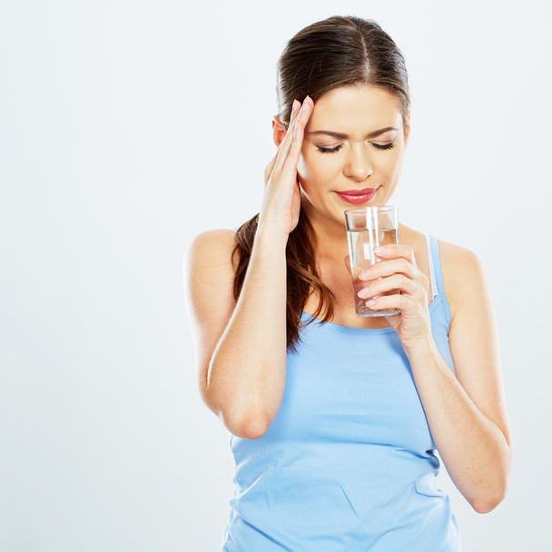 Woman with headache holds water - Valokuva, kuva
