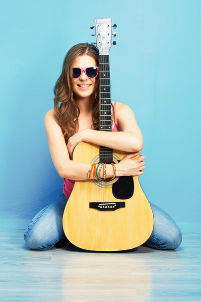 Woman sitting with guitar - Фото, изображение