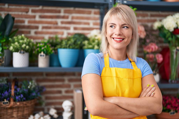 Young blonde woman florist smiling confident standing with arms crossed gesture at florist - Φωτογραφία, εικόνα
