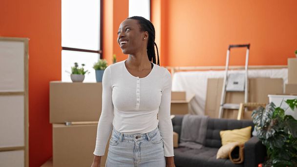 African american woman smiling confident standing at new home - Foto, Imagem