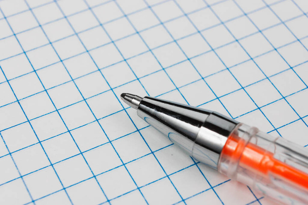 Grid paper with ballpoint pen closeup. High quality photo - Fotó, kép