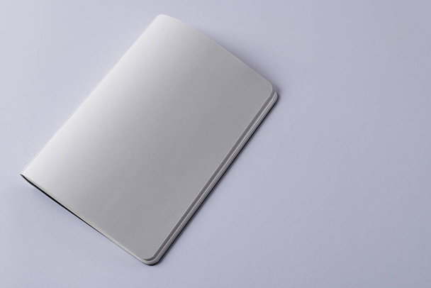 Close up of white notebook with copy space on white background. Literature, reading, writing, leisure time and books. - Foto, Bild
