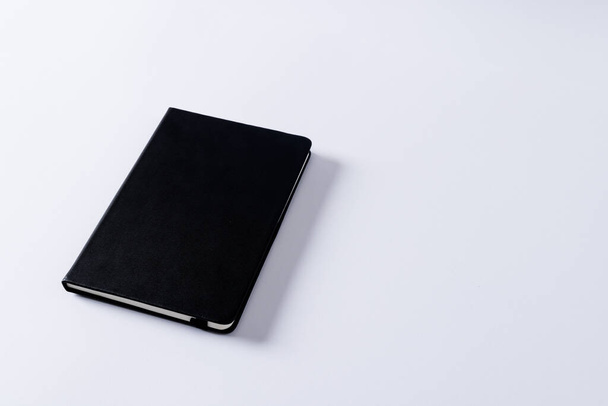 Close up of black notebook with copy space on white background. Literature, reading, writing, leisure time and books. - Фото, изображение