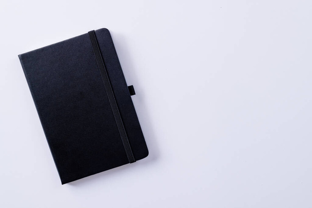 Close up of black notebook with copy space on white background. Literature, reading, writing, leisure time and books. - Fotó, kép