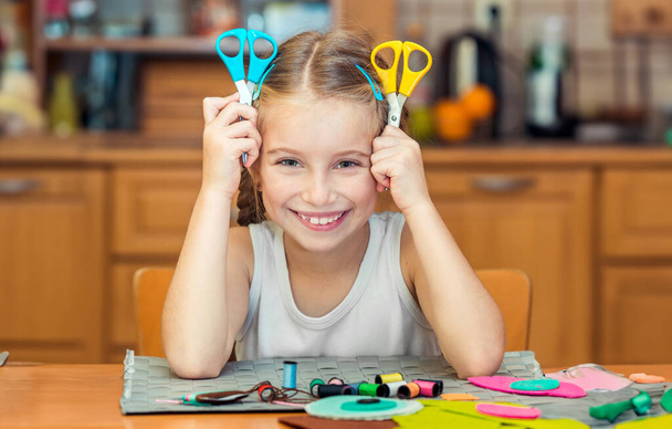 happy cute little girl shows two scissors - Photo, Image