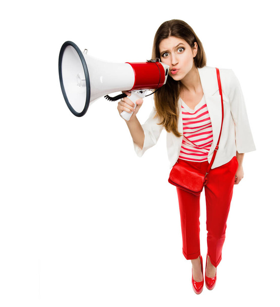Megaphone, fashion and portrait of a woman in studio for serious announcement, voice or speech. Weird and comic female model in trendy red clothes with a loudspeaker for breaking news or broadcast. - Fotoğraf, Görsel