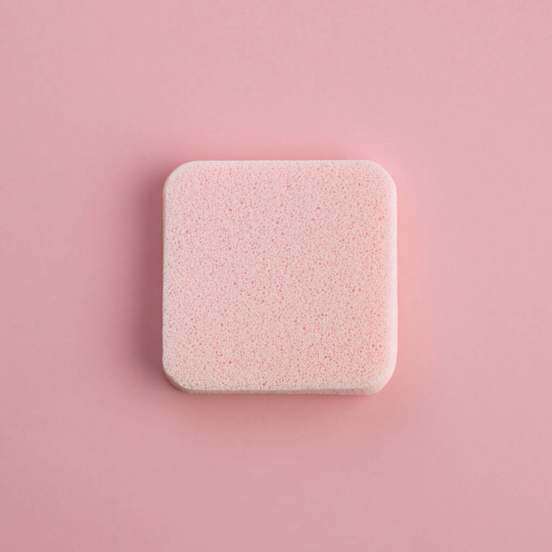 Cosmetic sponge on a pink background. Top view - Zdjęcie, obraz