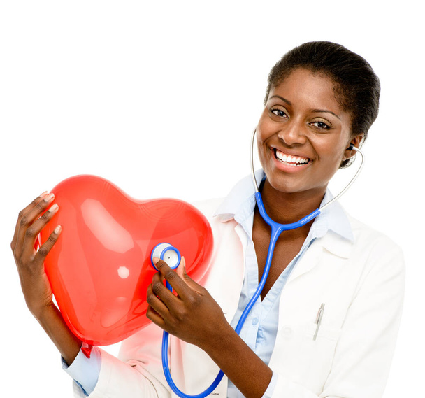 Love, woman doctor with heart balloon and against a white background with a smile. Support or care, portrait and African female surgeon isolated for health wellness against studio backdrop - Fotó, kép