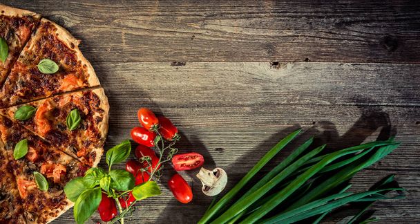 Vegetarian italian pizza with mushrooms on a wooden background with space for text - Foto, Bild
