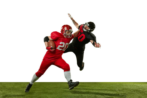 Men, american football players in motions, playing, training against white background. Game preparation. Concept of professional sport, action, lifestyle, competition and hobby, training, ad - Foto, Imagen