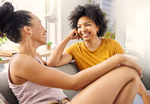 Friends, conversation and women on couch with smile, bonding and talking in living room to relax in support and love. Happiness, friendship and woman on sofa listening to gossip or discussion in home. - Photo, Image
