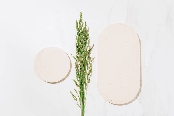 Flat lay cosmetics skin care product presentation scene and display with copy space made with podiums and summer grass. Studio photography. - Photo, image