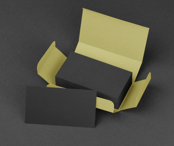 Black business cards in the beige box. - Foto, imagen