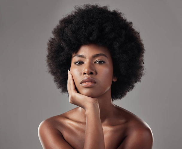 Skincare, black girl and makeup with confidence in portrait for wellness in studio background with afro. Beauty, face and glowing skin with african woman with cosmetics for dermatology with makeup - Foto, immagini
