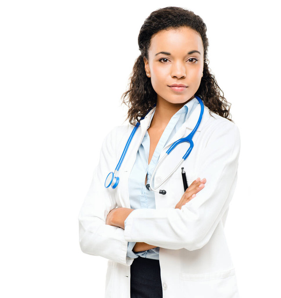 Doctor portrait, woman and arms crossed with a smile from healthcare and wellness career in studio. Young female worker, isolated and nursing with white background proud and confident from job. - 写真・画像