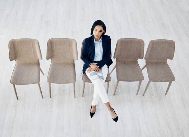 Business woman, waiting room and line of chairs for interview, hiring or recruitment at the office. Portrait of female person or employee sitting for appointment, meeting or career opportunity in row. - Photo, Image