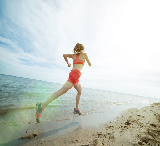 Lady running at the  beach - Фото, изображение