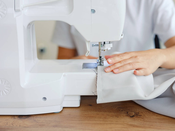 Fashion, fabric and sewing, woman at machine in small business with creative ideas and focus at home studio. Creativity, startup and design, tailor or designer stitching, young entrepreneur at work. - Foto, Imagen