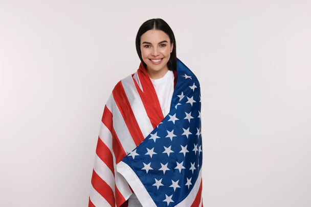 4th of July - Independence Day of USA. Happy woman with American flag on white background - Foto, Imagem