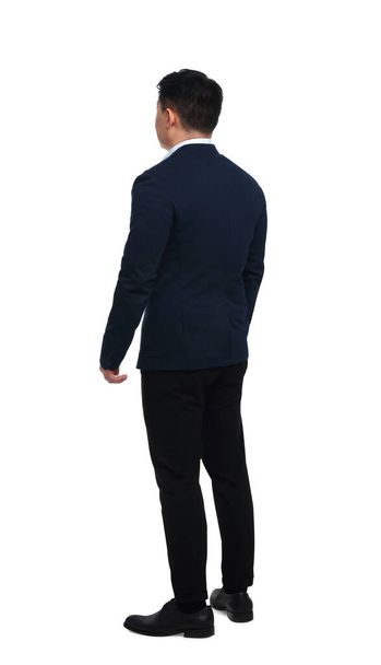 Businessman in suit posing on white background, back view - Foto, Imagem